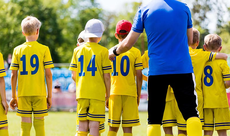 Soccer Coach Interacting with their team